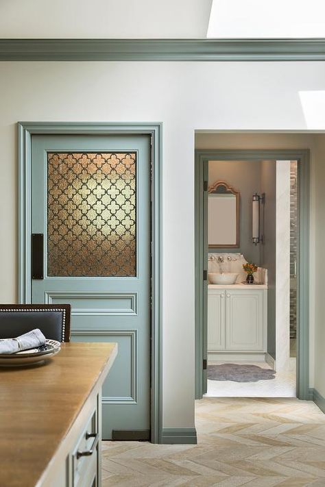 Gray kitchen pantry door with a frosted glass quatrefoil panel in a transitional kitchen with blue-gray crown molding and tan herringbone floor tiles. Frosted Bathroom Door, Frosted Glass Pantry Door, Glass Bathroom Door, Kitchen Pantry Doors, Glass Pantry Door, Glass Pantry, Frosted Glass Door, Glass Panel Door, Herringbone Floor