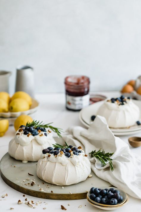 Pavlova with fresh berries and cream on a marble board What Is Pavlova, Meringue Nests, Mini Pavlovas, Mini Meringues, Baked Meringue, Berries And Cream, Mini Pavlova, Cream Fresh, Pavlova Recipe