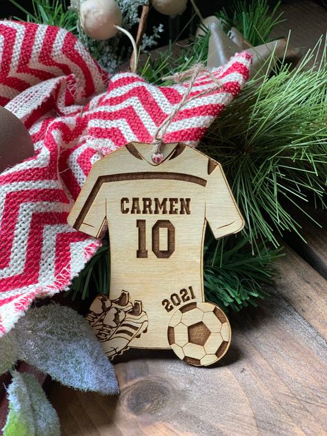 "This great Personalized Soccer Ornament will be a Stocking Stuffer for any Soccer Player on your shopping list this holiday season. The Soccer Ornament is Laser Engraved and Cut. Item Details: -4\" x 3\" -One Sided Ornament -Birch Plywood -Jute Hanger -Matte finish -Laser engraved and cut How To Order: Ordering is very easy, all you need to do is added it to your cart. Then in the Personalization box put the name, number and year would like for your ornament. If you have any questions please se Cool Engraving Ideas, Soccer Ornaments, Personalized Stocking Stuffers, Sports Ornaments, Cnc Machine Projects, Rugby Design, Personalized Stocking, Laser Cut Wood Crafts, Ornaments Personalized