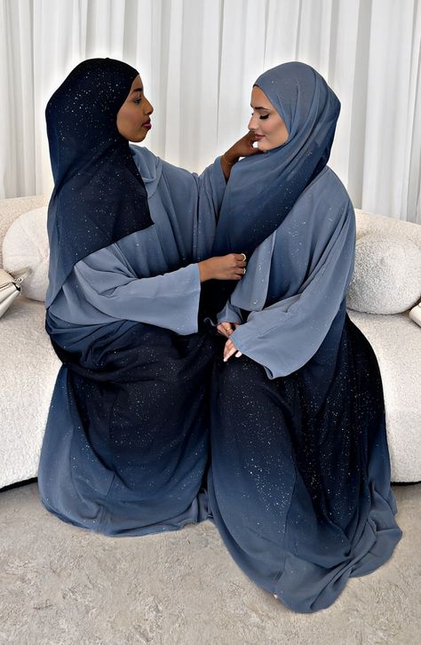 A loose butterfly style, open abaya made from a soft, ombré shaded, chiffon material. The abaya is lined for extra coverage and there’s small glitter detailing for that extra pizzazz! It comes with a matching glitter ombre hijab too! Suitable for all shapes and sizes because of the extra amount of material needed to make this style of abaya. You can wear it open or closed with the snap buttons that runs down the front. Material: Chiffon Sizes are based on length (52"- 56") and there may be 1-3 c Glitter Abaya, Ombre Hijab, Abaya Business, Elegant Abayas, Butterfly Abaya, Veil Ideas, Abaya Dresses, Fits Ideas, Glitter Butterfly