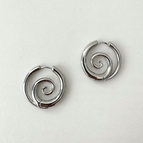 Elevate your style with these bold, spiral stainless steel hoop earrings. 100% stainless steel, 1" diameter. The modern design features small spiral in the center that add an edgy statement to any look. Made from durable stainless steel, these earrings have some weight to it, although comfortable for all-day wear, it might not be weight sensitive ears friendly. Add a touch of contemporary attitude to your ensemble with these standout hoops. We ship in 1-3 days, all purchases come with compliment Edgy Hoop Earrings, Endless Hoop Earrings, Earrings Edgy, Earrings Punk, Earrings Gothic, Edgy Earrings, Punk Earrings, Jewelry Gothic, Contemporary Earrings