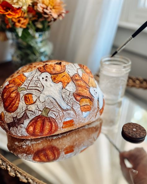 Spooky sourdough season! 🎃🍂👻 🎃🍁👉Join in on the fun! #myspookysourdough October challenge hosted by @artbreadlove , @petalandproof and myself! This Halloween-themed loaf features hand-painted ghosts, pumpkins, and candy corn, bats and spiderwebs. 🕸️🎃 🦇🍁 🖤baked using @kingarthurbaking bakers classic organic flour 🖤Scored with @wiremonkeyshop Poco lame and goose lame 🖤Painted using @suncorefoods and @gosupernatural natural food coloring! I paired with a vibrant bouquet for a festive aut... Halloween Sourdough, Halloween Bread, October Challenge, Vibrant Bouquet, Natural Food Coloring, Loaf Bread, Candy Corn, Natural Food, Food Coloring