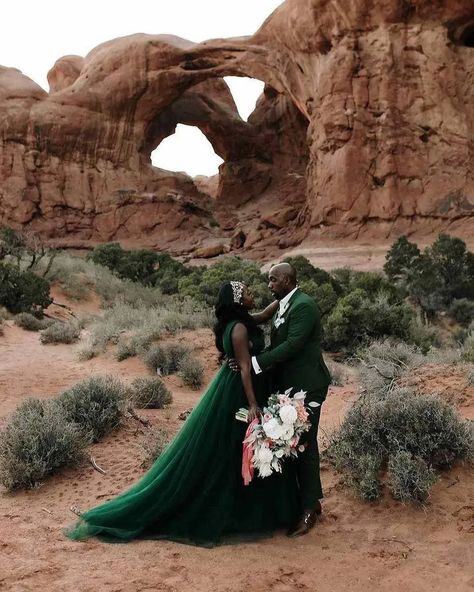 bride wearing a fairytale tulle sleeveless dark green wedding dresses in front of orange hued double arches Green Wedding Dress, Ribbon In The Sky, Green Pocket Square, Dead Horse Point State Park, Utah Desert, Wedding Tux, Green Wedding Dresses, Groomsmen Outfits, Emerald Green Weddings