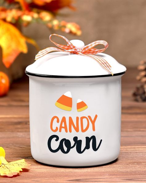 PRICES MAY VARY. Candy Corn Ceramic Canister-The package includes a jar printed with "Candy Corn". This canister is made of high-quality ceramic. Comes with a lid tied with a buffalo check bow. Mini Halloween Candy Holder-The canister measure approximately 4.9" tall and 3.7" wide.Ideal for holding some sweet candy, kitchen sauces, small Halloween ornaments, Halloween little tricks, etc. Autumn Holidays Table Centerpiece-Now is the time to start looking for fall holiday decorations for this year. Trick Or Treat Bowl, Halloween Gift Baskets, Holiday Table Centerpieces, Fall Candy, Table Farmhouse, Ceramic Canister, Autumn Table, Candy Holder, Farmhouse Decoration