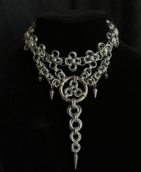 Transform your look with this striking handmade stainless steel chainmail necklace, featuring an elegant layered design, and a dramatic long centerpiece. Meticulously crafted, this necklace combines intricate chainmail techniques with a contemporary touch.  Features :  * Material : Premium stainless steel, offering durability, strength, and resistance to tarnish * Design :          - Layered Structure : Multiple layers of chainmail create a visually captivating, textured effect with rich depth Chainmaille Jewelry Patterns, Punk Necklace, Chainmail Necklace, Chainmail Jewelry, Chain Maille Jewelry, Layered Design, Chain Mail, Steel Necklace, Fantasy Jewelry