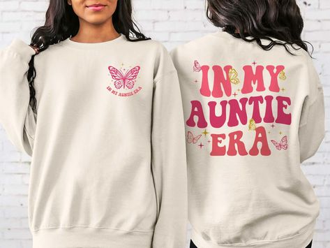 Rockatee on X: "Are you in your #AuntieEra? Show off your auntie pride with our comfortable and chic In My Auntie Era sweatshirt. Perfect for family gatherings or just cozying up at home. Get yours now! #auntie https://t.co/c3Cd0qM5bh https://t.co/UA8yDNKC9E" / X Vet Tech Shirt, Aunt Sweatshirt, Tummy Ache, Gifts For Veterinarians, Aunt Shirts, New Nurse, Nurse Sweatshirt, My Teacher, Vet Tech