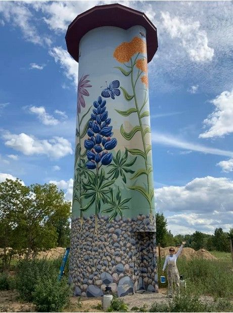 The mural depicts a scene of Michigan native wildflowers, bees, and butterflies on a 40ft tall grain silo in. The mural was painted in the summer of 2020 by artist local artist Ellen Nelson. This is her largest her largest mural to-date. Nelson says. “The owners of the property are moving to Tecumseh. They were originally going to tear down the silo, but they decided to go the other way and refurbish it and turn it into something everyone can enjoy.”​ Tecumseh Michigan, Coloring Wall, Silo Art, Street Chalk Art, Grafitti Street, Floral Mural, Where The Sidewalk Ends, Grain Silo, Bees And Butterflies