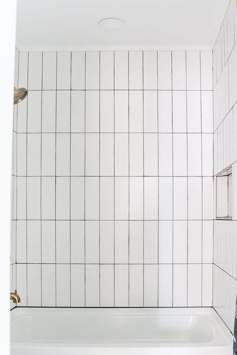 Vertical Tile Around Bathtub, Vertical Shower Tile Wall, White Vertical Stacked Subway Tile Bathroom, Vertical Subway Tile Tub Surround, Subway Tile Hung Vertically, 4x8 Subway Tile Bathroom, Shower Tile With Black Grout, White Vertical Stacked Subway Tile, Subway Tile Vertical Stack