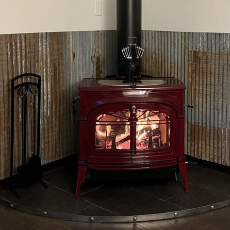 Protect your walls from the heat of a wood-burning stove with style. Lots of people, like our customer Darlene who recently installed some random mix barn tin wainscoting, have been using metal wainscoting as a heat shield behind these stoves. Wainscoting options: Barndominium With Tin Ceiling, Corrugated Metal Behind Wood Stove, Metal Behind Wood Stove, Corner Wood Burning Stove Ideas, Barn Tin Wall, Wood Stove Heat Shield, Metal Wainscoting, Tin Wainscoting, Corner Wood Stove