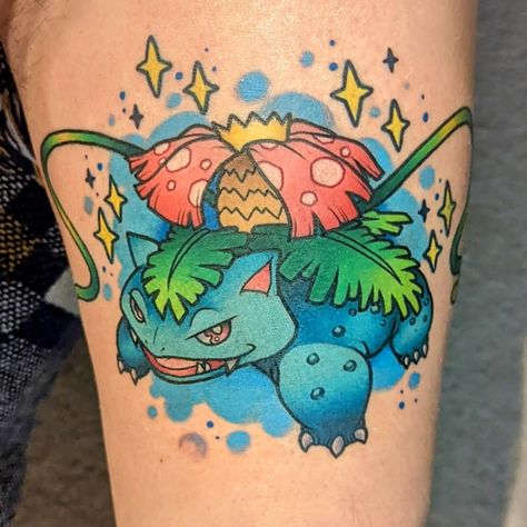 a zoomed in photo of a white person's thigh. there is a big, fresh full color tattoo of the pokemon venusaur, looking confident and ready for battle with vines flowing out from the base of the flower on its back. behind it is a dreamy blue cloud background and cute yellow sparkles Venusaur Tattoo, Bulbasaur Tattoo, Venusaur Pokemon, Pokemon Tattoo, Dark Matter, Rich Girl, Black Tattoos, Leg Tattoos, Art Forms