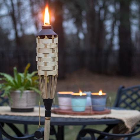 How to Use Tiki Torches to Light up Your Backyard | L'Essenziale Outdoor Light Ideas, Bbq Party Games, Bottle Torch, Huge Planters, Backyard Lighting Ideas, Can Lanterns, Tin Can Lanterns, Peaceful Evening, Outdoor Torches