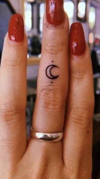 Finger tattoo designs Small finger tattoos Finger tattoo ideas Finger tattoo placement Finger tattoo Finger Tattoo Witch, Tiny Witch Tattoo Finger, Moon Sun Finger Tattoo, Finger Tats For Women Simple, Small Moon Finger Tattoo, Womans Finger Tattoos, Cute Knuckle Tattoos, Moon On Finger Tattoo, Moon And Sun Finger Tattoo