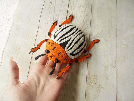 Felt colorado potato beetle is a cool present for all little naturalists. Felt dark butterfly can be used for educational games and for learning bugs. Also you can use it for Halloween decoration.  Felted colorado beetle I reccomend give only to kids 3+  SIZE Size of felted bug is about 15.5x12 cm. MATERIALS I make toy from high quality polyester felt. Carefully filled with hollowfibre. ATTENTION Colors may vary slightly from those shown on the monitor. Felt Insects, Felt Beetle, Felt Creatures, Felt Bugs, Diy Textiles Projects, Felt Toys Diy, Tovad Ull, Felt Kids, Lisa Frank Stickers