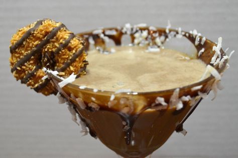 Samoa Cookie Cocktail 2 oz chocolate liqueur 1 1/2 oz caramel vodka 1 1/2 oz Malibu rum 1 oz half and half Put some chocolate syrup on a plate. Twist the edge of the glass into the syrup coating the entire rim. Then sprinkle coconut onto the glass into the syrup. Garnish with a cookie. Samoa Cookie, Samoa Cookies, Caramel Vodka, Malibu Rum, Chocolate Liqueur, Caramel Syrup, Almond Joy, Martini Recipes, Thirsty Thursday