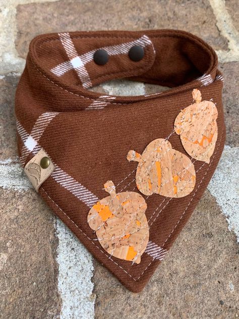 A high quality 100% cotton plaid bandana for your fur baby! A classy harvest plaid bandana whimsically stitched with 3 cork acorns. Let him or her stand out among the dogs Perfect for thanksgiving, pumpkin farm visits or any fall pictures.  I love this bandana! Machine wash and tumble dry. Do not iron over the cork. NECK SIZE OPTIONS: X-small up to 10" Small 11-13" Medium 14-16" Large 17-19" X-large 20-22" XXL 23"-25" When ordering, please leave me a message in the "note to seller" section at checkout with your pets neck size This is a high quality bandana with two layers of cotton and a middle layer of flannel to allow it to drape beautifully on your dog.  All my bandanas are topstitched for extra durability and a snap closure or tie on for easy on and off.  To finish it off, my faux leat Fall Bandana Dog, Thanksgiving Dog Bandana, Sewing Projects For Dogs, Dog Neckerchief, Flannel Dog Bandana, Orange Dog, Dog Thanksgiving, Diy Sewing Gifts, Puppy Bandana