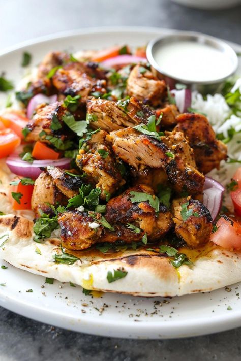 Indulge in the exotic flavors of Middle Eastern cuisine with this delicious chicken shawarma recipe. Marinated in a blend of aromatic spices, this dish is bursting with tender and juicy goodness. Whether grilled to perfection or roasted in the oven, chicken shawarma is sure to satisfy your taste buds. Pair it with fluffy pita bread, fresh vegetables, and creamy tahini sauce for a complete meal that will transport you to the streets of Lebanon. Chicken In Pita Bread, Chicken Shawarma Plate, Pita Chicken Recipe, Mediterranean Pita Recipes, Pita Jungle Chicken Recipe, Chicken Shwarma Breast, Chicken Swarma Meal Oven, Chicken Shawarma Recipe Authentic, Chicken Shwarma Meals