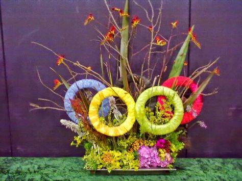 Olympic Flower Arrangement, Olympic Ring, Olympics Decorations, Floral Art Arrangements, Olympic Flame, Olympic Rings, Knitted Washcloths, Olympic Torch, Event Display