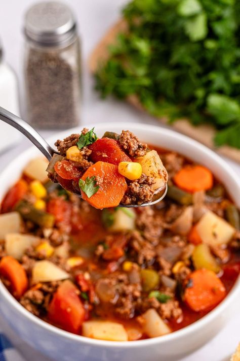 Can’t choose between a burger and soup for dinner? How about mixing the best of both worlds and whipping up some hamburger soup? You’ll get all those mouthwatering hamburger flavors in a warm, comforting bowl. With hearty beef, vibrant veggies, garlic, and a sprinkle of Italian herbs, this hamburger soup is a total winner. Add a handful of shredded cheddar cheese on top and the kids will love it too (and they'll be eating their vegetables without complaint!) This recipe is quick, easy and tasty. Best Hamburger Soup Recipe, Easy Hamburger Soup, Soup For Dinner, Soup With Ground Beef, Cheese Puff Pastry, Easy Hamburger, Italian Herbs, Hamburger Soup, Shredded Cheddar Cheese