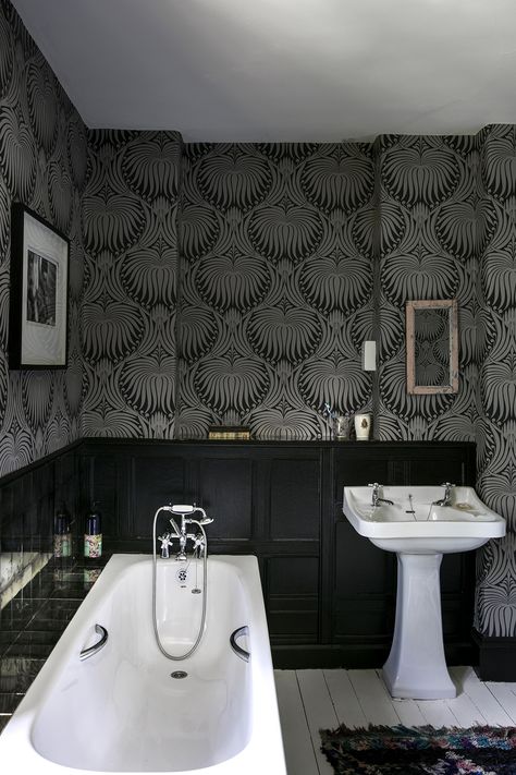 Nature inspired wallpaper is sure to create a modern rustic vibe. This bathroom's dark wainscotting perfectly compliments the wallpaper letting it shine. #RusticHomeDecor #RusticBathroom #RusticBathroomIdeas Black Wainscoting, Monochrome Bathroom, Wainscoting Bedroom, Wainscoting Bathroom, Simple Bathroom Remodel, Black White Bathrooms, Dark Bathrooms, Laundry Room Bathroom, Rustic Bathrooms