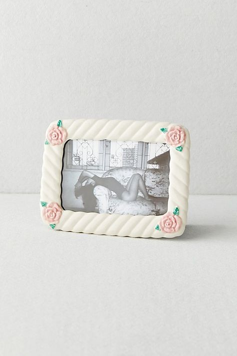 Turn your photo gallery into a vintage-inspired display with this stoneware picture frame featuring swirled detailing with rosebuds at the corners. Display it on your shelves with an easel stand at the back. Available exclusively at Urban Outfitters. Features Vintage-inspired picture frame from UO Home Swirled detailing paired with rosebud icons for a femme look Ready to display with an easel stand at the back Holds one 5x7 photo Content + Care Stoneware, MDF Wipe clean Imported Size Dimensions: Cricut Picture Frames, Diy Collage Picture Frames, Polaroid Albums, Urban Outfitters Decor, Frames Polaroid, Australia Clothing, Cute Picture Frames, Unique Picture Frames, Preppy Gifts