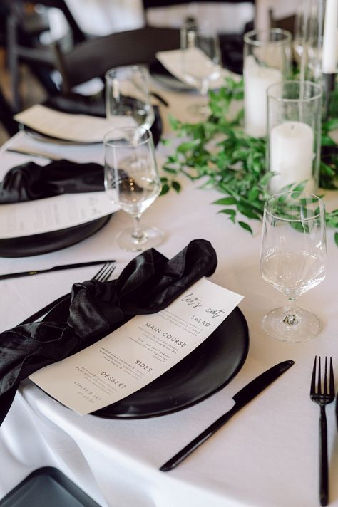 Obsessed with this black place setting starring shimmering satin napkins atop matte Onyx Earthen China 🖤 Black Plates Table Setting Wedding Ideas, Black On Black Wedding Decor, Wedding Place Settings Black And White, Black And White Round Table Setting, Black Place Setting, Wedding Napkin Ideas, Wedding Napkin Folding, Round Table Settings, Wedding Flatware