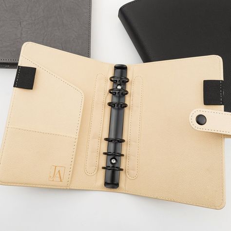 A gorgeous pale blonde hue with black hardware, this premium vegan leather planner cover is for six ring planners.  A beautiful premium pebble grain vegan leather planner cover that adds instant class and luxury to your favorite six ring planner setup. Two front interior pockets, black hardware, and two over-sized elastic pen loops make the planner cover extremely functional too! We had these planner covers manufactured to our exact specifications and the quality shows. We've even been told they A5 Planner Cover, Black Metal Rings, Leather Planner Cover, Bullet Journal Minimalist, Happy Planner Cover, Lifestyle Planner, Planner Setup, Discbound Planner, Ring Leather