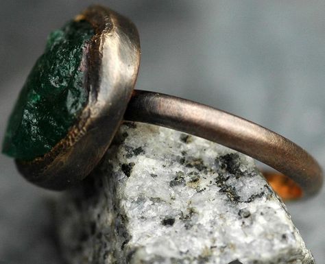 Here’s one of my gigantic raw emeralds set into my hand-fabricated oxidized 18k rose gold engagement and wedding ring set. Each of these ring sets is designed around a large, untreated raw emerald that I source specifically for the project. I have been setting uncut emeralds, diamonds, sapphires and rubies (as well as most of the semi-precious category of gemstones) into my work since 2008. Get in touch if your dream ring is centred around the raw and the rough. #rawemerald #roughemerald ... Gold Engagement And Wedding Ring, Engagement And Wedding Ring Set, Engagement And Wedding Ring, Raw Emerald, Wedding Ring Set, Rose Gold Engagement, Dream Ring, Gold Engagement, Wedding Ring Sets