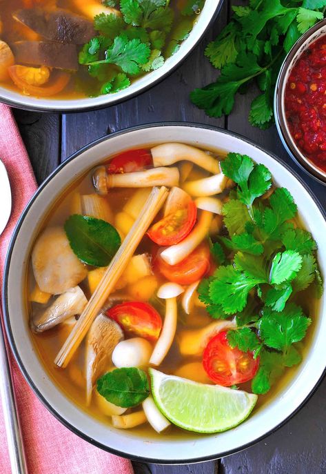 This vegetarian tom yum soup recipe is light, flavourful, spicy and hearty all at the same time. A mix of meaty Asian mushrooms are poached in a fragrant broth of lemongrass and lime leaves and soured with lime juice. A spoonful of chili paste is stirred in at the end for a bit of heat to warm you up and you’ve got a nourishing, steaming bowl of soup that’s great for chilly weather. Tom Yum Soup Recipe Vegetarian, Vegan Tom Yum Soup, Vegan Tom Yum, Clear Broth Soups, Tom Yum Soup Recipe, Canh Chua, Vegetarian Thai, Thai Coconut Soup, Tom Yum Soup