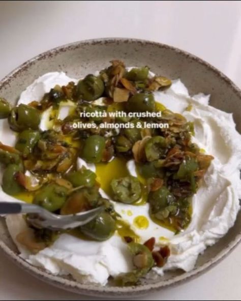 Heathy Eating on Instagram: "Ricotta With Crushed Olives, Almonds & Lemon 🍋 by @liv.kaplan

Ingredients
¼ cup slivered almonds
½ cup Sicilian olives, crushed and pips removed
1 tbsp capers
¼ cup parsley, fresh, leaves and stems chopped
⅓ cup extra virgin olive oil
½ lemon, zested and juiced 
370g smooth ricotta

Method
Place the slivered almonds in a pan over a medium heat. Toast for 4-5 minutes until slightly golden. Toss them occasionally with a wooden spoon to ensure they don’t burn. Set aside in a bowl.
Turn the heat to low then add in the olives, capers and parsley, followed by the olive oil. 
Stir in the lemon zest and juice and allow all the flavours to infuse for 10 minutes  over the low heat. 
Meanwhile, spread the ricotta on a plate. 
Pour over the olive oil mixture and top with Sicilian Olives, Squash Ravioli, Medium Recipe, Butternut Squash Ravioli, Whipped Feta, Snack Dip, Cracker Snacks, Red Sauce, Wooden Spoon