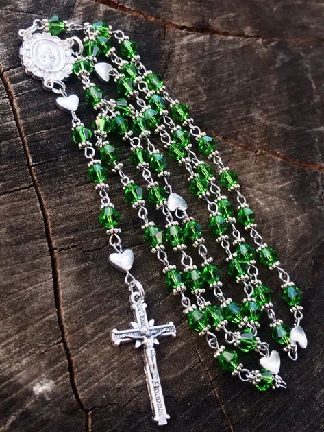 This Catholic Rosary is made with 6mm  Green Glass Bicone Beads, Silver Plated and Stainless Steel Findings, Silver Plated Bead Caps, Silver Plated heart Beads as the Our Father Beads, a traditional Catholic Crucifix and a Mother Mary Centerpiece.  This Rosary is made the traditional chain Catholic way, each Bead is hand Beaded and chained, which makes the Rosary strong and very sturdy. It's made with Stainless steel findings, silver plated Findings, a traditional centerpiece and Traditional cru Green Rosary, Catholic Crucifix, Rosary Beads Catholic, August Birthday, Catholic Rosary, Our Father, The Rosary, Rosary Catholic, Rosary Beads