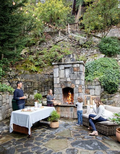 The flagstones, exterior stone hearth and retaining walls create an ideal spot for dining. | Photographer: Janis Nicolay | Designer: Ami McKay, Pure Design Inc. Forest Home Landscaping, Retaining Wall Fireplace, Cedar And Stone Exterior, Traditional Fireplaces, Mountain Garden, Garden Fireplace, Stone Hearth, Cottage Landscape, Forest Homes