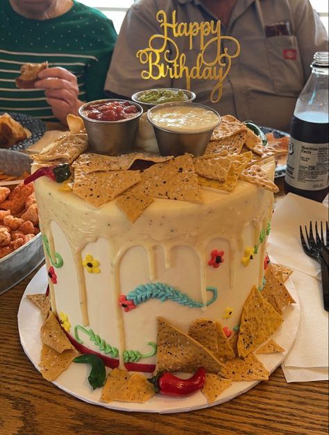 a mexican restaurant themed birtnday cake with ganache “queso” drip, fondant tortilla chips and jalepenos, with real cups of queso, salsa, and guacamole sat on top. Chipotle Themed Party, Taco Party Cake, Taco Birthday Cake, Mexican Birthday Cake, Taco Cake, Salsa And Guacamole, Salsa Party, Mexican Cake, Birthday Fiesta