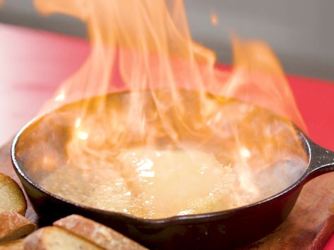 Flaming Cheese (Saganaki) | This decadent cheesy appetizer is easy to make, fun to serve, and sure to impress. Enjoy this gooey, buttery melted cheese dish right from the skillet with plenty of toasted bread. Kasseri is a Greek cheese made from a blend of sheep and goat’s milk; good kasseri cheese can be found at Middle Eastern markets, or you can purchase a block online. Flaming Cheese Greek, Kasseri Cheese Recipes, Saganaki Cheese Recipe, Cheese Saganaki, Flaming Cheese, Kasseri Cheese, Amazing Dips, Party Pies, Cheese Breads