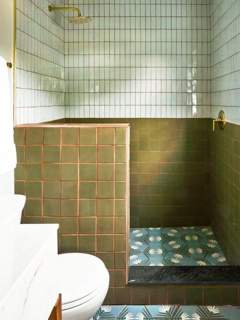 Rebuilt with a pony wall to create an expansive walk-in shower, the suite’s bath is color-blocked in style with handmade olive squares beneath subway tiles in a vertical soldier stack and gorgeous floral hexes underfoot. Less is more in close quarters like these, so Mika and Grace made their statements with high-quality essentials and let those luxe finishes speak for themselves rather than cluttering the space with tchotchkes. Shower With Pony Wall, Half Wall Shower Ideas, Pony Wall Shower Ideas, Pony Wall Ideas, Motel Renovation, Square Tile Bathroom, Half Wall Shower, Matte Tiles, Brick Bathroom