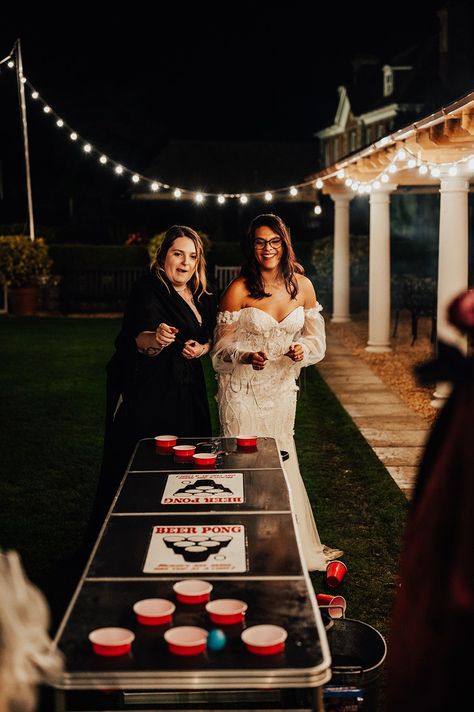 The bride in a beaded floral wedding dress plays beer pong on black shiny table Wedding Ideas Alcohol, Fun Wedding Activity Ideas, Fun Activities Wedding, Cool Ideas For Weddings, Fun Diy Wedding Ideas, Wedding Games Diy, Unique Wedding Dinner Ideas, Fun Non Traditional Wedding Ideas, Game Table At Wedding