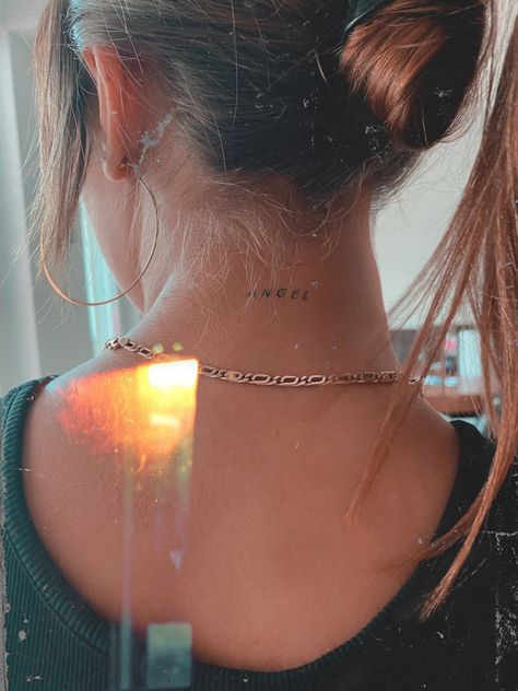 Angel Tattoo Behind Neck, Womens Small Neck Tattoos, Tiny Back Of Neck Tattoo, Back Of The Neck Tattoos Words, Angel Tattoo Neck Woman, Angelic Aesthetic Tattoo, Tiny Neck Tattoos For Women Words, Small Tattoo Back Of Neck, Pretty Back Of Neck Tattoos Women