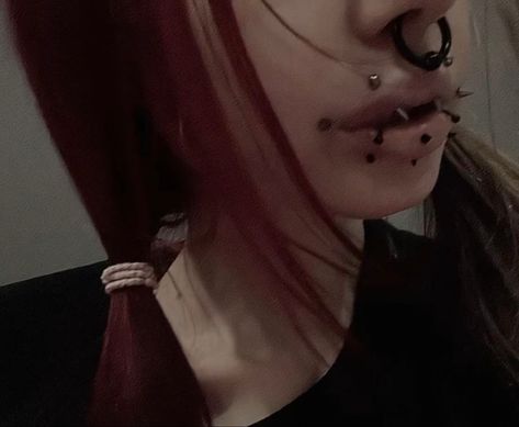 angel fangs, dahlia piercings, spike dahlia, snake bites, vertical labret, septum, red hair, black piercings Black Snake Bites Piercing, Vertical Angel Bites, Angel Fangs And Snake Bites, Dahlia Bites, Angel Fangs Piercing, Piercing Setup, Dahlia Piercing, Black Piercings, Angel Fangs