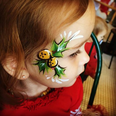 Holly and bells face paint for Christmas #facepaint #holiday #holly #christmas #bells Body Painting Pictures, Balloon Face, Body Paintings, Chili Cookoff, Professional Face Paint, Christmas Face Painting, Cheek Art, Christmas Crafty, Face Painting Easy