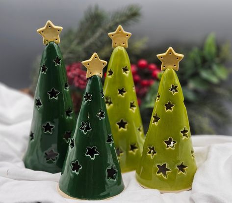 I crafted these luminary trees and carved them by hand.  The star pattern shows up beautifully when lit.  The star on top gives these rustic trees an elegant look and will enhance just about any holiday decor.  I used a high quality, very durable brown speckled stoneward clay and high fire glazes on them for lasting beauty.   The glazes I used are semi-transparent to show off the speckled clay.  (except for the evergreen one) They range from about 5.5 to 6 to 6.5 inches tall.  Choose from the dr Teachers Presents, Holiday Pottery, Wine Cork Christmas Tree, Christmas Pottery, Pottery Christmas, Clay Christmas Decorations, Ceramic Christmas Decorations, Train Decor, Pottery Ornaments