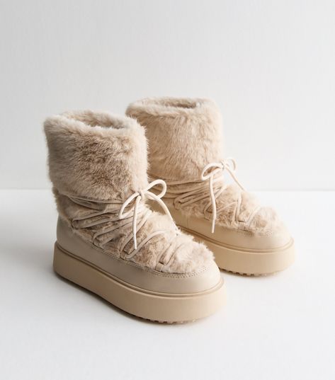 New Look Off White Faux Fur Lined Boots. Soft faux fur make these chunky boots extra cosy. Battle the unpredictable weather in style. They're made with Comfort.  features for a comfy fit that lasts all day. This piece is registered by The Vegan Society and is completely animal free. Material: faux fur Fit: standard Shoe Style: boots Colour: off white Fastening: slip on Toe: round toe Lining: faux fur Design: lace up, chunky sole. Comfort: a range of styles designed with features such as cushione Fur Snow Boots, Wedding Guest Shoes, Fur Lined Boots, Faux Fur Boots, Skirt Co Ord, White Faux Fur, Fur Boots, Wide Fit Boots, Chunky Boots