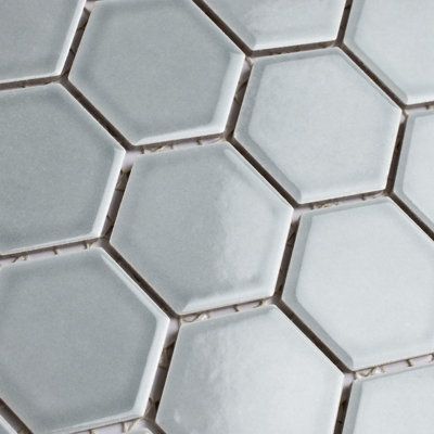 Lending a unique touch of color, this porcelain mosaic floor, and wall tile instantly elevate spaces through a refreshing dose of vivid geometric design. As an innovative twist on the classic hexagon, this mosaic is comprised of hexagonal chips with a smooth surface. Glossy hexagons are arranged on an interlocking mesh to create a seamless installation. This minimalistic geometric porcelain mosaic is unique yet simplistic enough to integrate into any design, ranging from traditional style renova Tile Color, Mosaic Floor, Ceramic Mosaic Tile, Merola Tile, Hexagonal Mosaic, Porcelain Mosaic Tile, Accent Tile, Mosaic Flooring, Natural Stone Tile