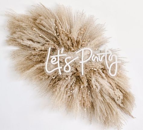 Neon sign "Let's Party" on top of pampas grass swag Pampas Grass Backdrop, Boho Salon Decor, Fall Floral Table, Pampas Arrangement, Arch Arrangement, Grass Backdrops, Case Studio, Boho Backdrop, Boho Wedding Flowers