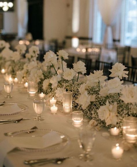 Classic White Wedding Theme, Long Table Wedding Centerpieces Candles White Flowers, White Flowers And Candles Wedding, Modern Minimalist Wedding Table Decor, Neutral Wedding Aesthetic, Wedding Theme Ideas Elegant Indoor, White Roses Centerpieces Wedding, Vintage Classic Wedding Aesthetic, Long Table Floral Arrangements