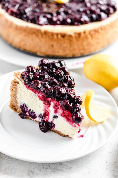 This Lemon Blueberry Cheesecake features an ultra creamy, smooth and tangy lemon cheesecake studded with fresh blueberries. Topped with a sweet blueberry sauce, this dessert deserves to be apart of your summer baking plans! | queensleeappetit.com Blueberry Lemon Cheesecake, Summer Cheesecake, Mascarpone Cake, Lemon Blueberry Cheesecake, Blueberry Topping, Cheesecake Toppings, Blueberry Sauce, Summer Baking, Cream Cheese Eggs