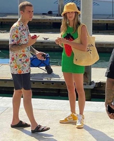 Hailey Bieber wore a Y2K-inspired summer look. She accessorized a strawberry-adorned green sweater vest from JW Anderson’s resort 2022 collection, with a knit bucket hat, Prada knit tote bag, and sportive sneakers. Nike Dunk High Outfit, Dunk High Outfit, Dunks Outfit, Green Sweater Vest, Hailey Bieber Style, Blue Jean Outfits, Outfits With Hats, Hailey Bieber, Nike Dunk