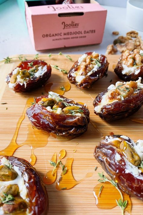 These savory goat cheese stuffed dates make for a quick and delicious appetizer! Topped with crunchy walnuts and pistachios, fresh thyme and a yummy drizzle of honey perfect for entertaining, snacking, and more. The tart and tangy goat cheese pairs perfectly with the natural sweetness from the medjool dates. This appetizer is not only delicious, but chalked full of nutritional benefits! This is a no sweat appetizer that comes together in less than 10 minutes and will without a doubt impress gues Goat Cheese Stuffed Dates, Cheese Dessert Recipes, Honey Appetizers, Cheese Stuffed Dates, Dates Recipes, Marscapone Cheese, Spanish Tapas Recipes, Stuffed Dates, Pastry Appetizer