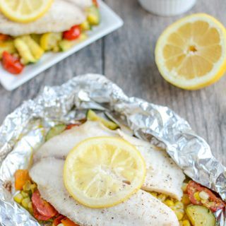 This recipe for Grilled Foil Packet Tilapia with Pesto Veggies is perfect for a summer dinner! It's quick, easy and healthy, plus cleanup is a breeze! Pesto Veggies, Grilled Foil Packets, Foil Meals, Campfire Dinners, Spicy Almonds, Grilled Tilapia, Foil Packet Dinners, Zucchini Recipes Healthy, Foil Pack Meals