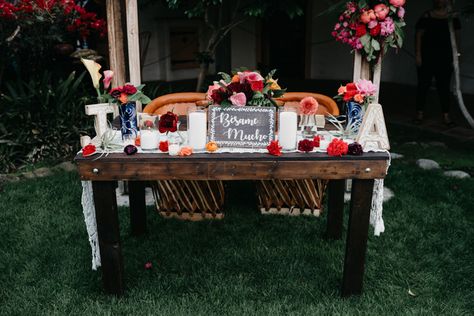 Mexican wedding sweetheart table with lots of traditional mexican flowers and colors. Equipal chairs and farmhouse table, draped with lace, traditional spanish candles. Wedding Sweetheart Table Ideas, Romantic Sweetheart Table, Mission San Luis Rey, Mexican Wedding Decorations, Mexico Theme, Sweetheart Table Ideas, Wedding Felt, Wood Table Decor, Orange Chairs