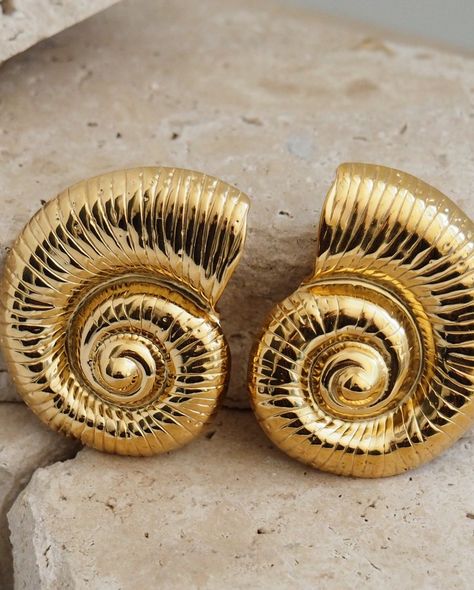 The Aniloso earrings 🤍🎀 Shell yeah! Snail is associated with wisdom, persistence, patience, peace, self-care, and harmony. These bold gold snail earrings are the perfect gift for anyone who loves to make a statement. With their dome shape and trendy spiral design, they’ll add a touch of drama to any outfit. Available for N9,000 only. Snail Earrings, Shell Yeah, Spiral Design, Chain Link, Self Care, Bangles, Drama, Perfect Gift, Gold