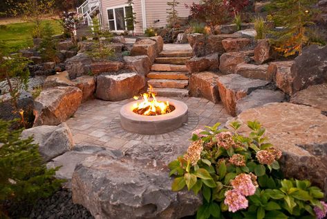 Rustic Sunken Fire Pit, Pebble Rock Fire Pit Area, Xeriscape Fire Pit, Landscape Around Fire Pit, Outdoor Stone Fireplace Ideas, Hillside Fire Pit, Natural Fire Pit, Outside Fire Pits, Backyard Fire Pit